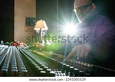 Sound control panel professional. Sound designer working on the sound control. Man working on professional digital audio channel mixer in studio