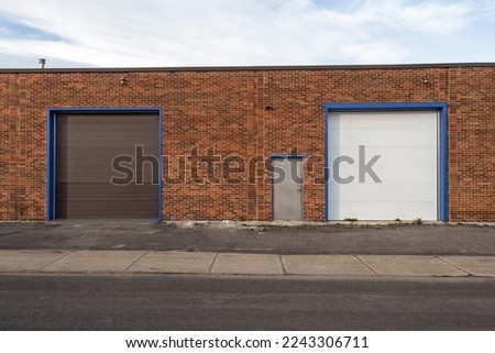Generic loading dock of a small business building exterior Royalty-Free Stock Photo #2243306711