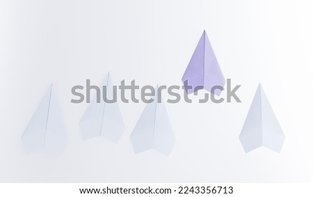 Group of origami planes on white background.