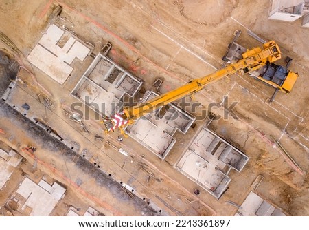Construction crane moving precast concrete walls