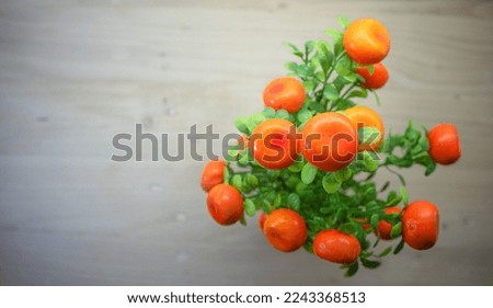 Plastic fake mini tomato trees are usually used for home decoration