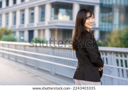 A woman in a suit walking in the business district