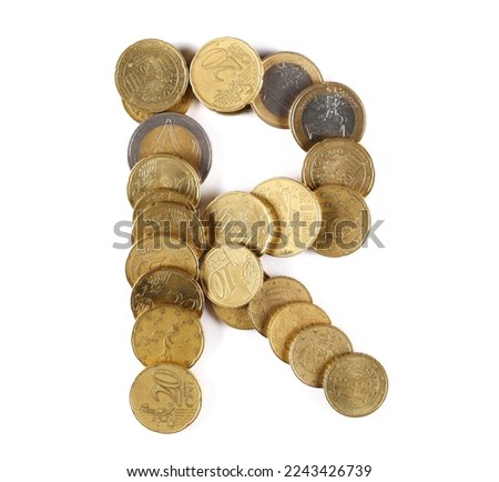 Euro metal coins in shape letter R isolated on white, top view