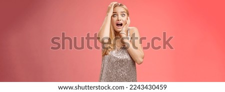 Shocked terrified blond woman horrified see crime screaming pop eyes shouting hold hands head afraid trembling fear standing frightened drop jaw gasping face terrible accident, red background. Royalty-Free Stock Photo #2243430459