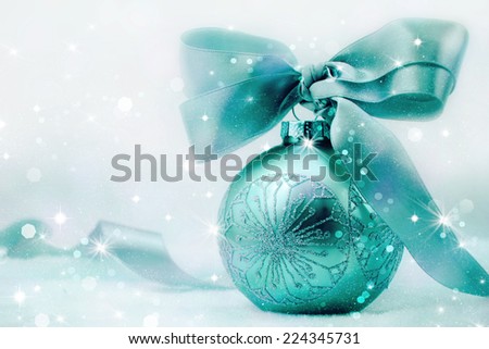 Christmas ball with bow in winter snow. 