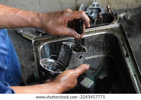Human hands cleaning car part