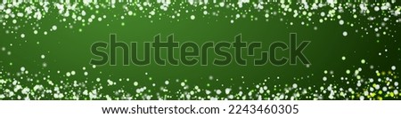 Magic falling snow christmas background. Subtle flying snow flakes and stars on christmas green background. Magic falling snow holiday scenery.   Panoramic vector illustration.