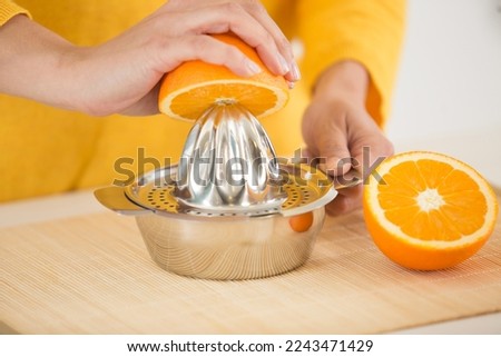hands squeezing the juice of an orange Royalty-Free Stock Photo #2243471429