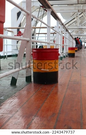 Aru Islands- Indonesia, December 30 2022 Red, yellow, black trash cans made of iron are on the deck of the ship. Royalty-Free Stock Photo #2243479737