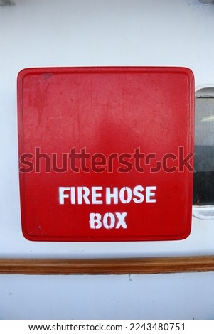 Aru Archipelago- Indonesia, 30 December 2022 A fire hose box made of red iron is on board a ship which is used as emergency equipment in case of fire. Royalty-Free Stock Photo #2243480751