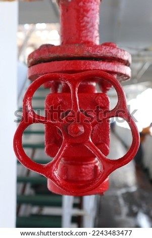 Aru Islands- Indonesia, 30 December 2022 round of red valve fire hydrant which is a fire extinguishing system that uses pressurized water as its medium. Royalty-Free Stock Photo #2243483477