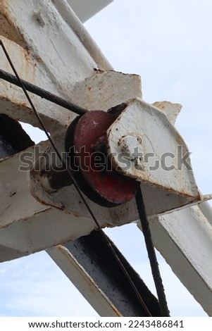 Aru Archipelago- Indonesia, 30 December 2022 Roller mechanisms made of iron are used to lower ship lifeboats in emergencies. Royalty-Free Stock Photo #2243486841