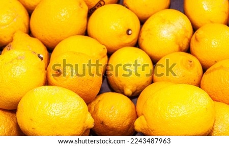 top view, close up of, a group of local, freshly picked, ripe lemons, at a farmers market in St. Remy, France