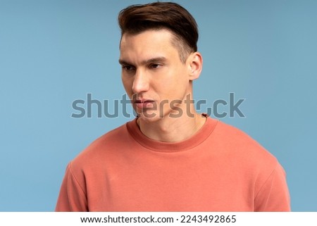 Portrait of attentive self confident man looking at camera with serious expression, unsmiling determined business man. Indoor studio shot isolated  Royalty-Free Stock Photo #2243492865