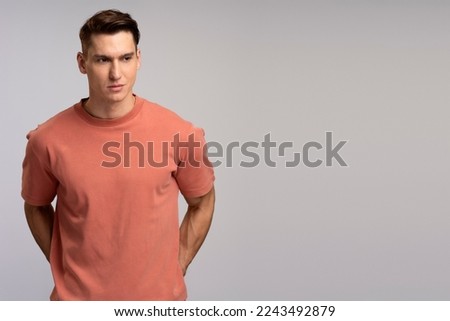 Portrait of attentive self confident man looking at camera with serious expression, unsmiling determined business man. Indoor studio shot isolated  Royalty-Free Stock Photo #2243492879