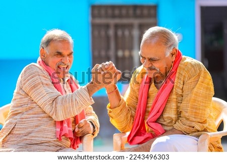 Old and senior indian farmers standing and giving happy expression