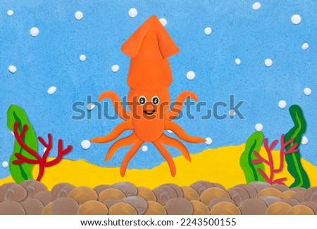 orange squid made from plasticine on colorful under water background