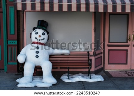 Snowman sitting on the bench