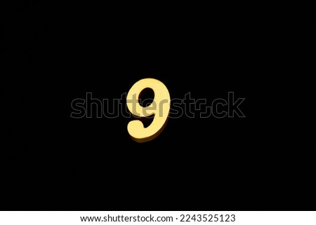 Arabic numerals made of wood, painted in gold, visible in a "3D illustration" or "3D rendering" style, placed on a black background.