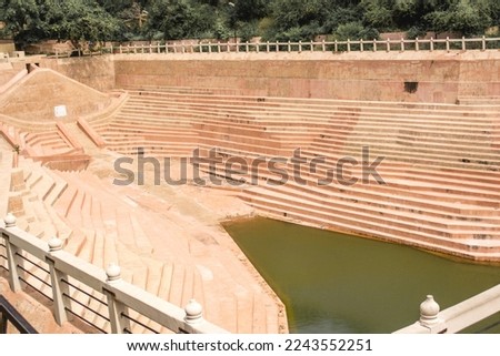 The historical staircase at the nahargarh fort in jaipur with a small water pond in the center of the stairs. It is an outdoor locations of the for.