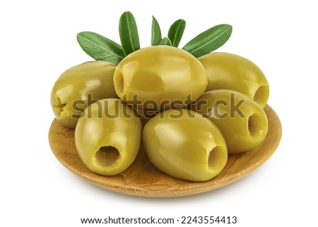 Green olives with leaves in wooden bowl isolated on a white background with full depth of field.