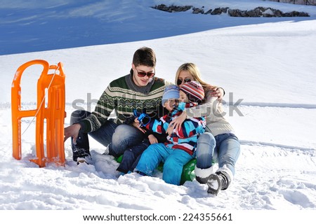 Winter season. Happy family having fun on fresh snow on vacation