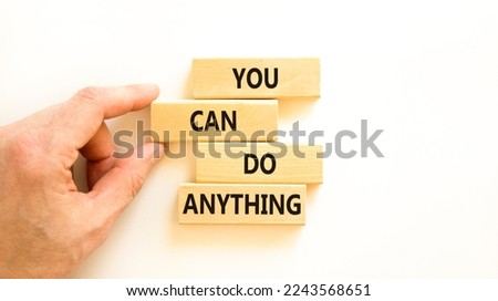 You can do anything symbol. Concept word You can do anything on wooden blocks. Businessman hand. Beautiful white table white background. Business and you can do anything concept. Copy space.