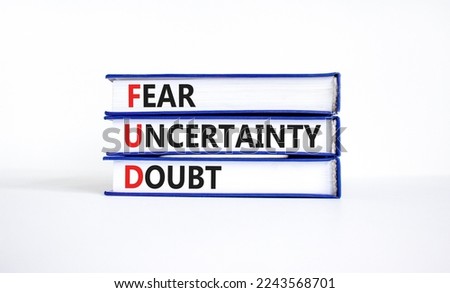 FUD fear uncertainty doubt symbol. Concept words FUD fear uncertainty doubt on books on a beautiful white table white background. Business and FUD fear uncertainty doubt concept. Copy space.