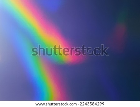 photo of abstract pastel iridescent silver holographic foil background with light leaks. holo color plastic material. cool glitter surface with shiny rainbow feel. Royalty-Free Stock Photo #2243584299
