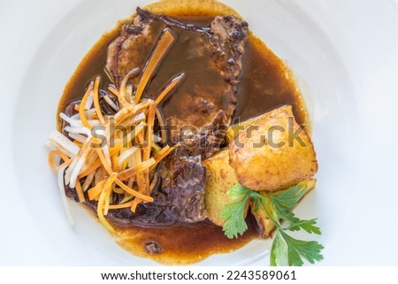 fine Esterhazy roast beef in sauce with fried potatoes