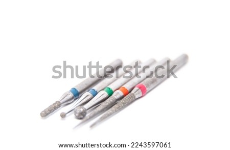 Diamond dental burs in close-up isolated against a white background. Dental tools for removing cavities and treating teeth. Teeth drilling. Royalty-Free Stock Photo #2243597061