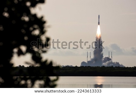 Rocket launching from rocket stage at Cape Canaveral, FL. Digitally enhanced. Elements of this image furnished by NASA. Royalty-Free Stock Photo #2243613333