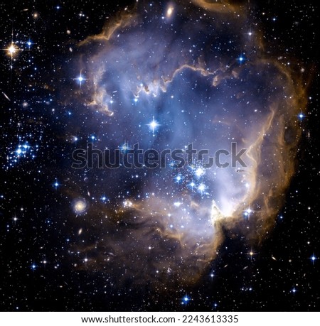 Small Magellanic Cloud, there's a region where new bright stars are forming. The stars are so powerful that they are creating a cavity within the nebula. Digitally enhanced. Elements of image by NASA Royalty-Free Stock Photo #2243613335