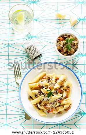 pasta with eggplants on a light background. tinting. selective focus on parsley