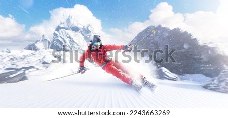 Rapid descent at high speed. Skier skiing on a sunny day in high mountains. Downhill. Ski skiing in mountains. Skiing descent at high speed. Snow dust