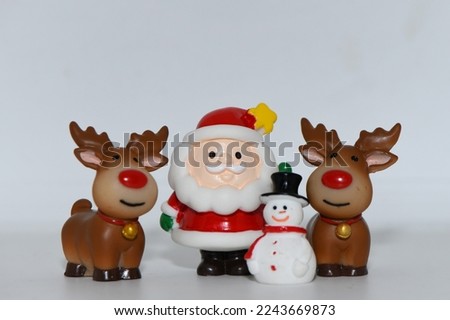 Santa Claus and Reindeers with snowman figure at Christmas Festival.