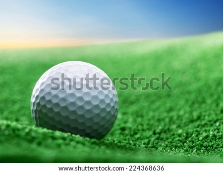 Close up of golf ball on green tee