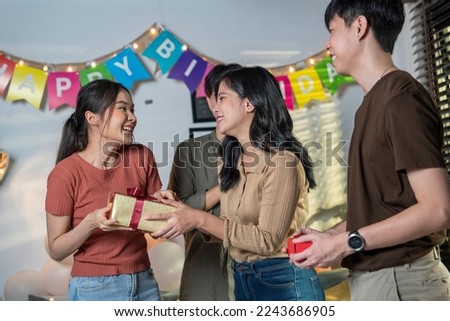 Boyfriend and girlfriend come to birthday party Friends bring gift boxes to surprise them for their birthday party.