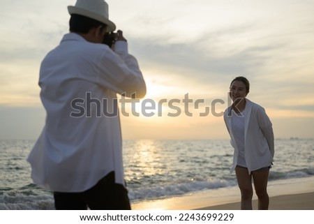 Young couple taking photos with beautiful sea view, Happy people enjoying on beach, Beach therapy, Beach travel