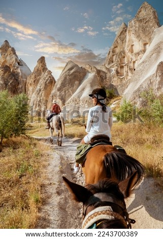 Young woman on a horseback during a vacation in Turkey Kapadokya watching Cappadocia