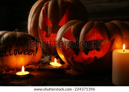 Halloween pumpkins on brown wooden background