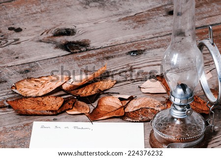 Old fashioned letter with a lamp and leafs