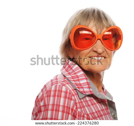  Senior woman wearing big sunglasses doing funky action isolated on white background 