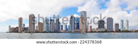 Miami skyline panorama in the day with urban skyscrapers and cloudy sky over sea 