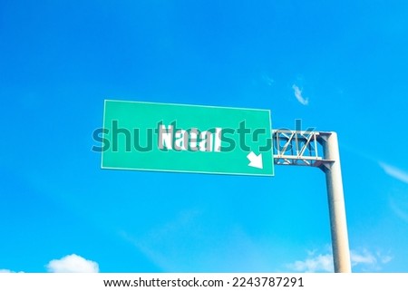 The name of the city Natal on a green road sign.
