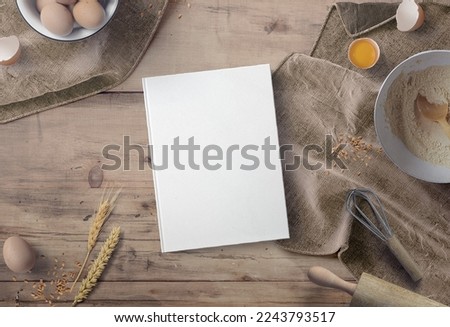 hardcover cookbook mockup with different cooking materials and equipments 