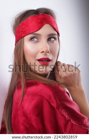 Shocked young lady, covers mouth with hand	
