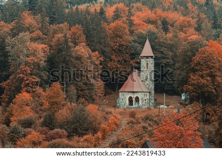 An old church built of stone on a hill. Beautiful autumn scenery. Landscape photography
