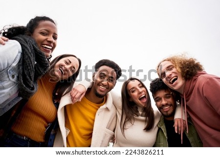Happy friends from diverse cultures and races taking selfie looking at camera outdoors. Cheerful people having fun. High quality photo