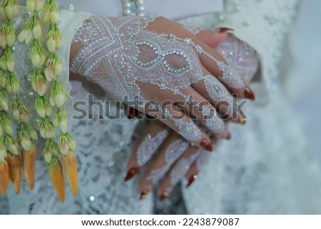 the beauty of hands with henna ornaments and a mix of traditional Indonesian